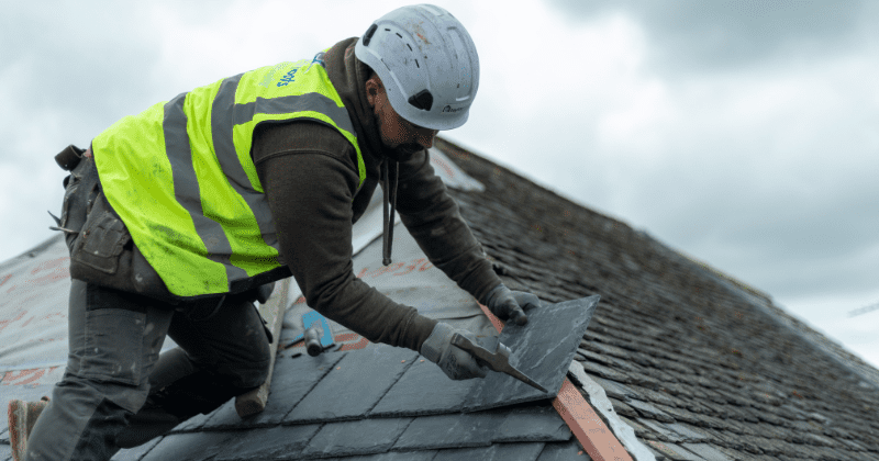 Roofer sizing Spanish slate.